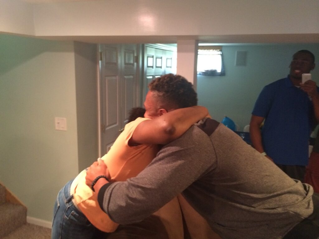 Khairi Fortt hugs his mother Tabitha moments after being drafted by the Saints.