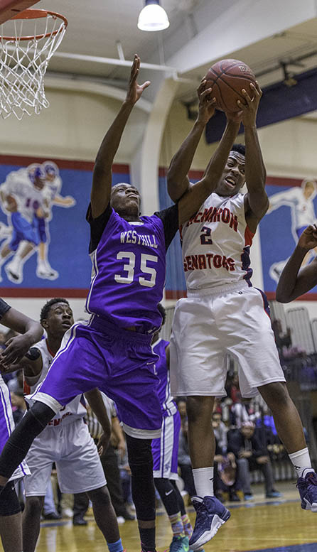 Westhill High School’s and McMahon’s David Civil battles Westhill's Jmai Graham for a rebound. (Photo: Mark Conrad)