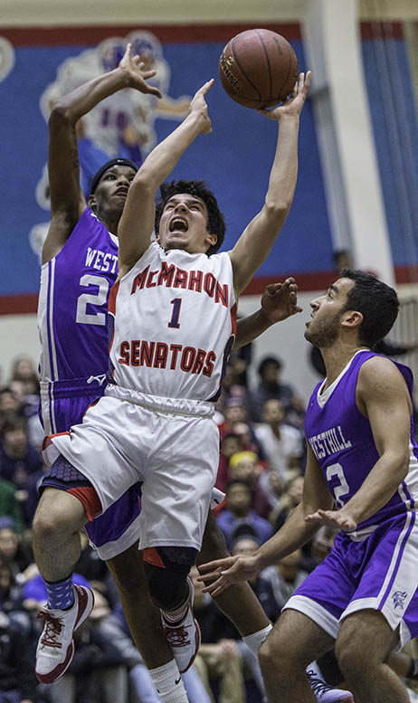 McMahon’s Brendan Huertas goes in for a layup between two Westhill defenders. (Photo: Mark Conrad)